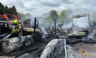 Firefighters extinguishing fire at scrap yard