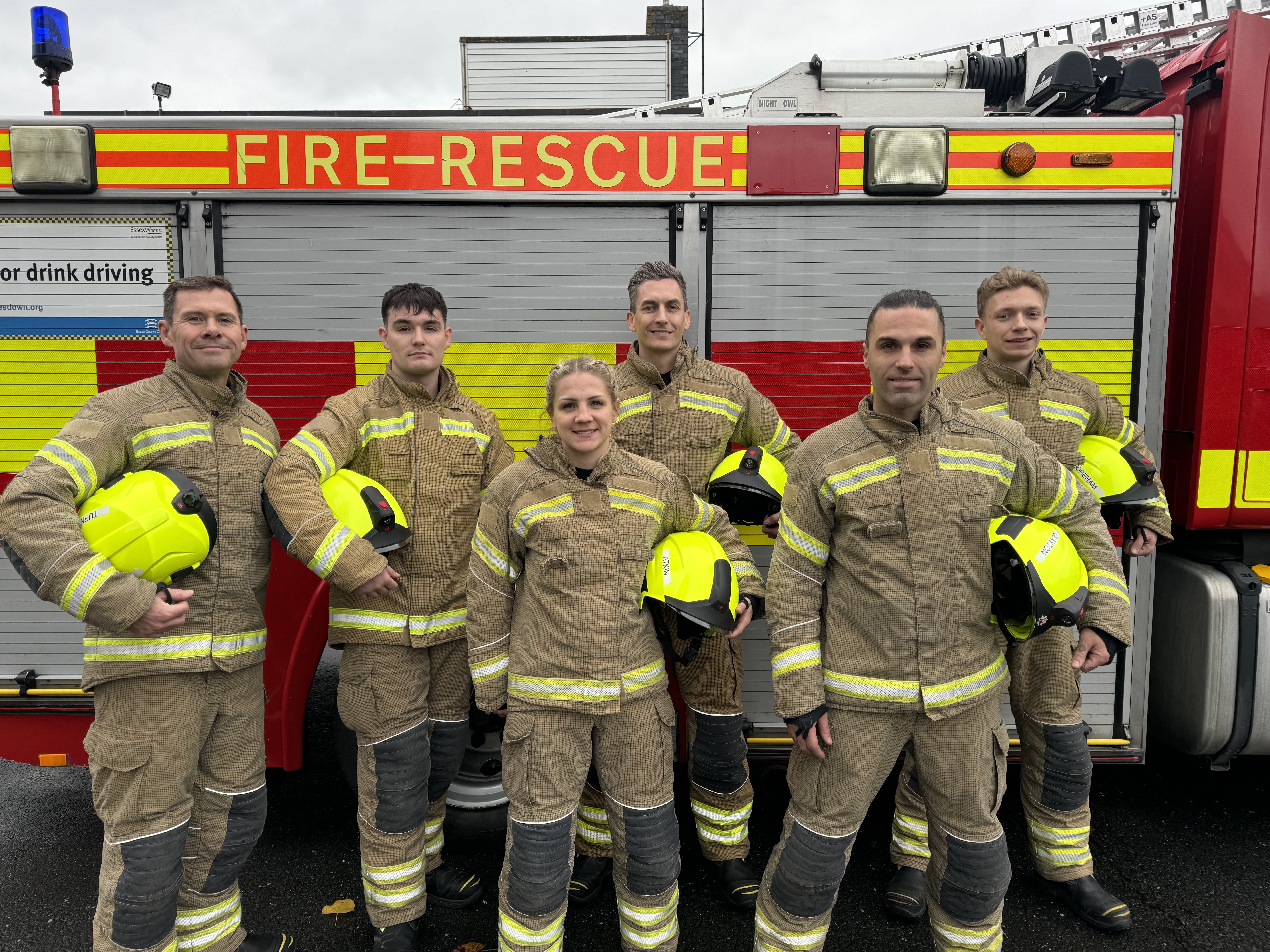 Six new on-call firefighters stand infront of fire engine