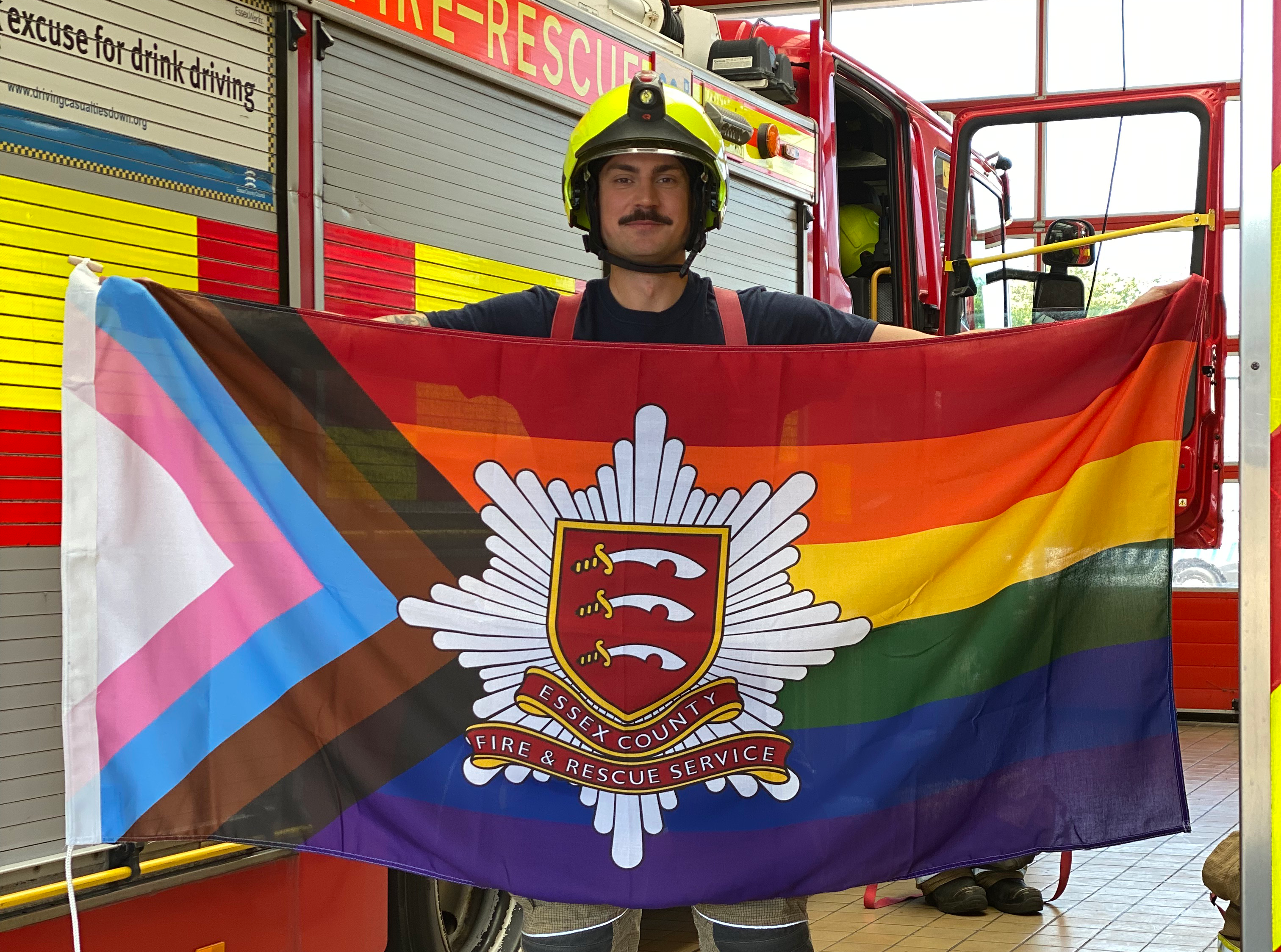Firefighter Matt Hill holding the progress flag