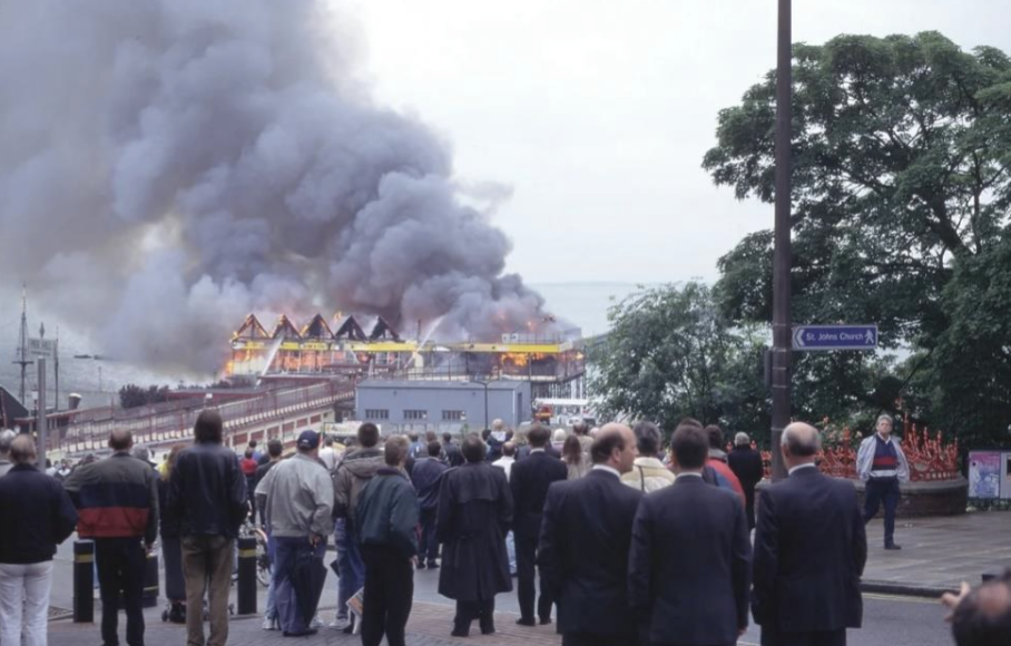 Crowds gathering at the scene of a fire at Southend Pier