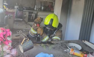 A firefighter in the burnt out kitchen