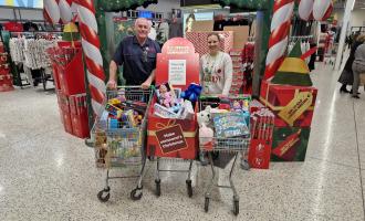 Les Nicoll with volunteer shopping for Christmas hamper donations