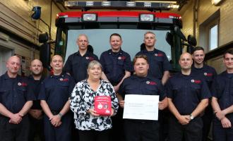 Crews at Tiptree Fire Station presenting a cheque to Julie Taylor, from the Liam Taylor Legacy.