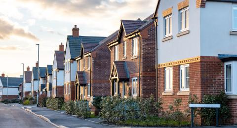 Series of terraced new builds at dusk