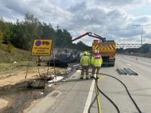 two firefighters assessing the scene of a lorry fire