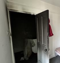 A smoke logged door that prevented smoke entering a bedroom during a fire