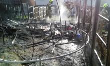 Firefighters worked to extinguish a garden fire