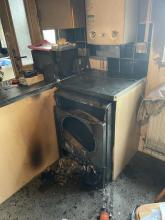 A kitchen smoke damaged after a tumble dryer fire