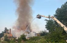 Firefighters using an Aerial Ladder Platform to tackle a fire in a derelict building
