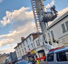Firefighters using an Aerial Ladder Platform to tackle a fire in a derelict building