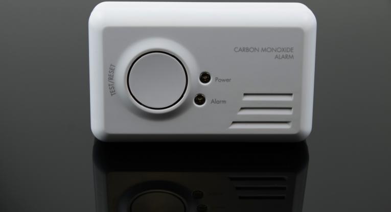 Standard Carbon Monoxide Detector placed on black reflective surface